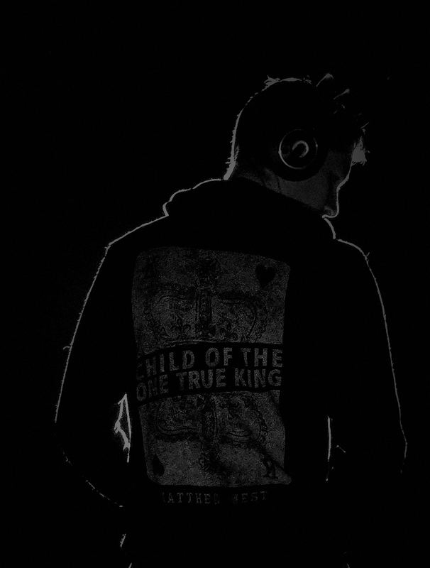Benjamin wearing headphones in a dark studio